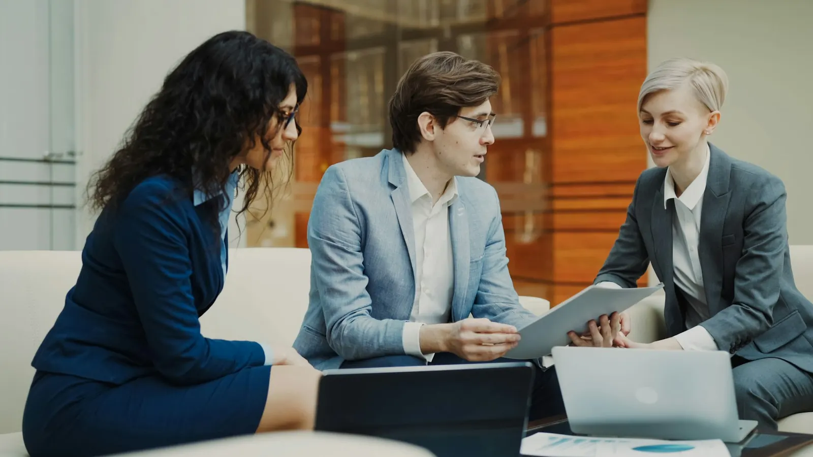 Colleagues comparing answers on a laptop